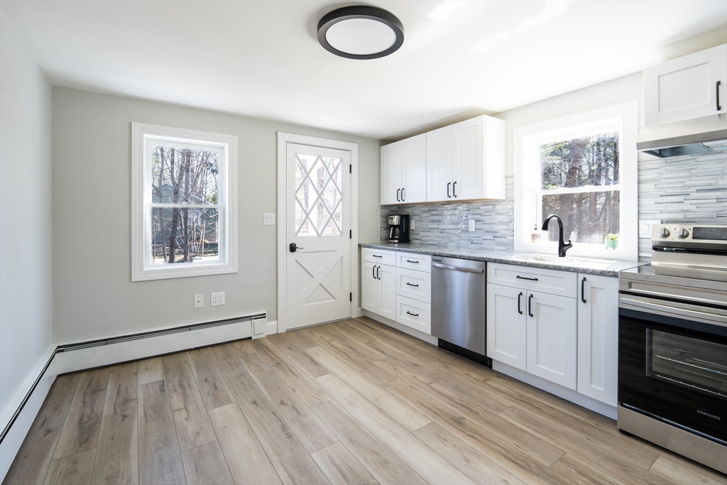 1049 Pleasant Street Canton, MA 02021 - Photo 6 of 34 a kitchen with a sink cabinets stainless steel appliances and a window