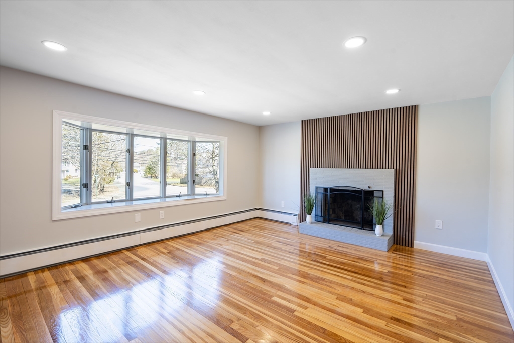 1049 Pleasant Street Canton, MA 02021 - Photo 7 of 34 a view of an empty room with wooden floor and a window