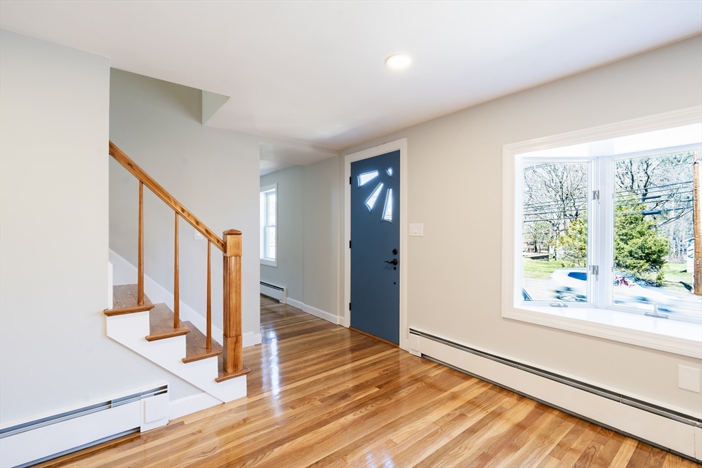 1049 Pleasant Street Canton, MA 02021 - Photo 10 of 34 a view of an entryway with wooden floor and door