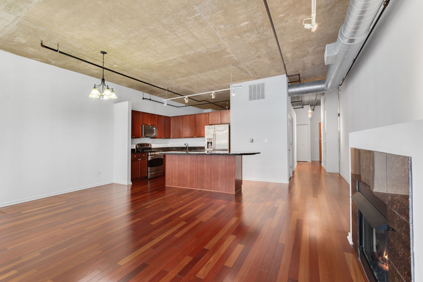 520 South State Street, Unit 705 Chicago, IL 60605 - Photo 11 of 33 a view of a kitchen with wooden floor and electronic appliances