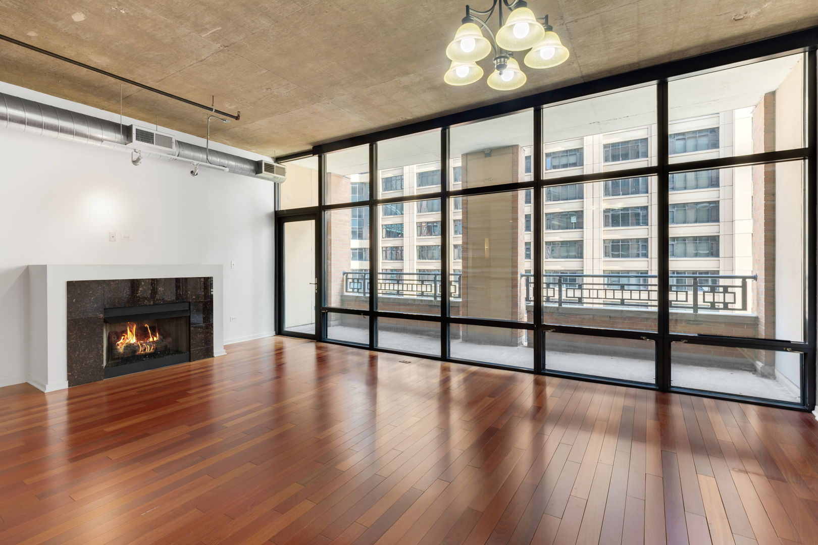 520 South State Street, Unit 705 Chicago, IL 60605 - Photo 15 of 33 a view of an empty room with wooden floor fireplace and a window