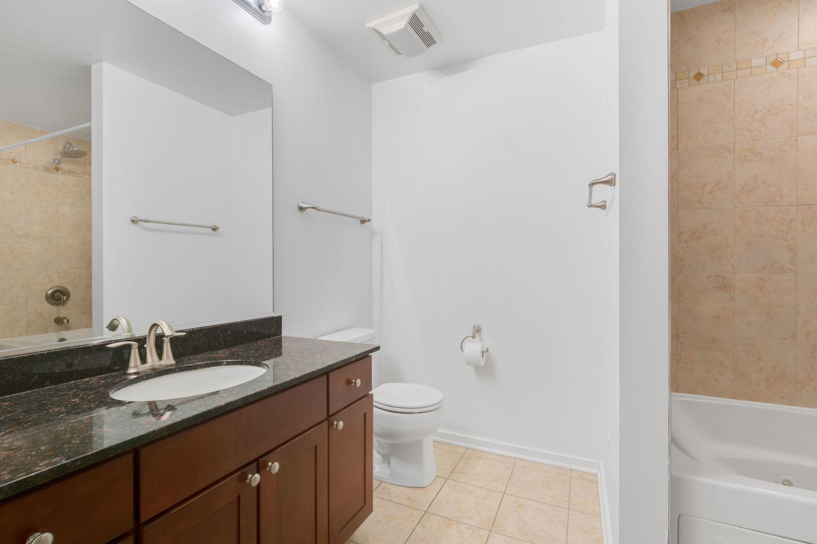 520 South State Street, Unit 705 Chicago, IL 60605 - Photo 23 of 33 a bathroom with a granite countertop sink a toilet and a mirror