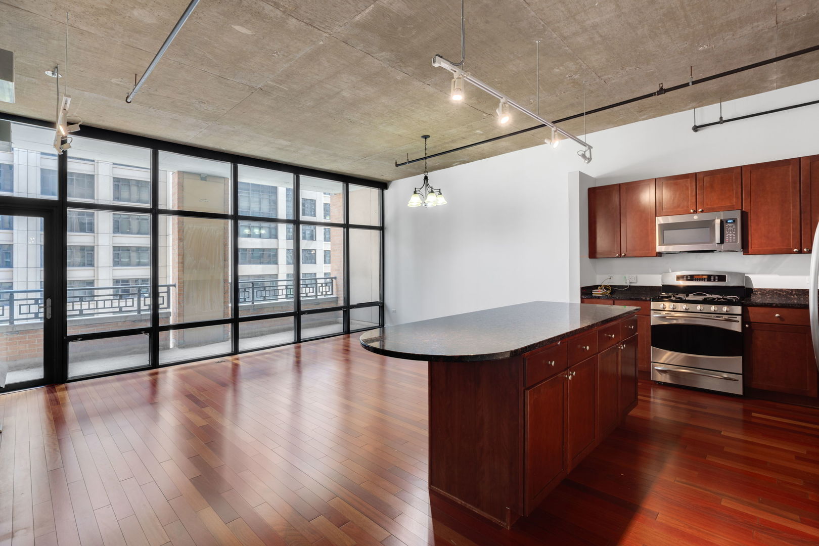 520 South State Street, Unit 705 Chicago, IL 60605 - Photo 7 of 33 a kitchen with stainless steel appliances granite countertop a stove and a wooden floors