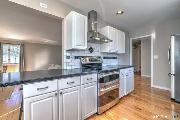 a view of a kitchen with a sink and cabinets
