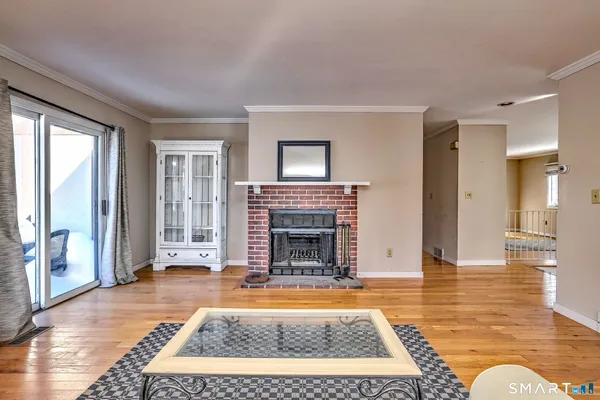 a living room with a fireplace and a rug