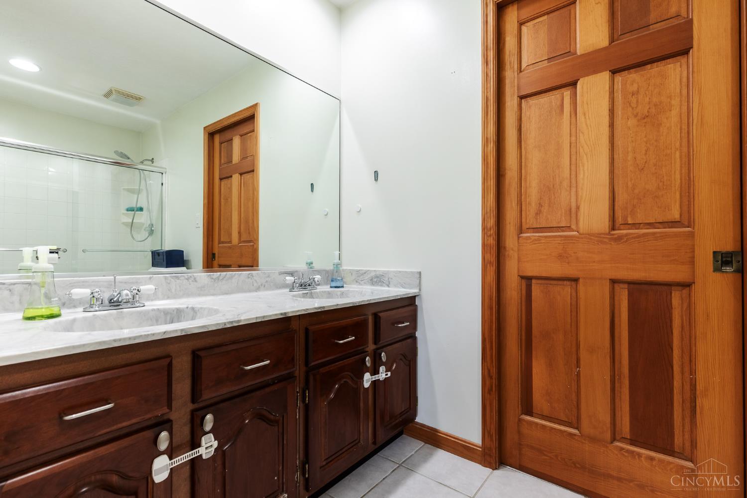 623 Ibold Road Loveland, OH 45140 - Photo 23 of 35 Connecting the home's two secondary bedrooms, the Jack & Jill bath offers a generous dual-sink vanity, shower with glass enclosure, and a practical layout designed for everyday convenience.