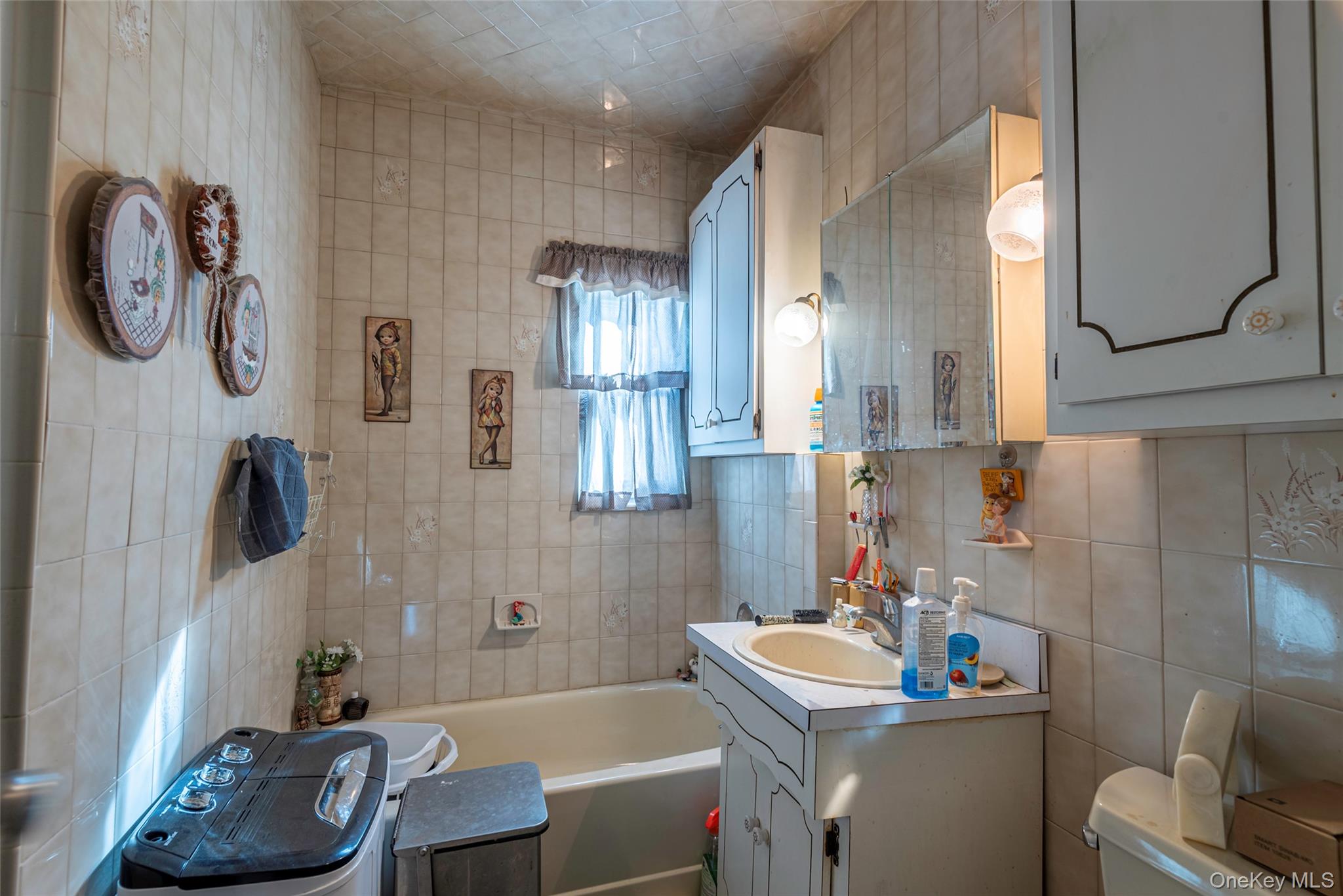 43 Wynsum Avenue Merrick, NY 11566 - Photo 9 of 23 a bathroom with a sink toilet and a mirror