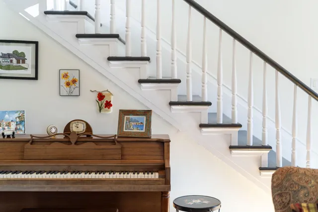 a view of staircase with white walls and a window