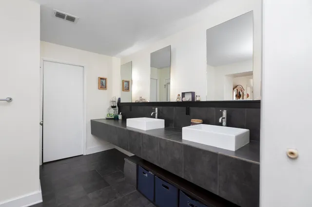 a bathroom with a double vanity sink and a mirror