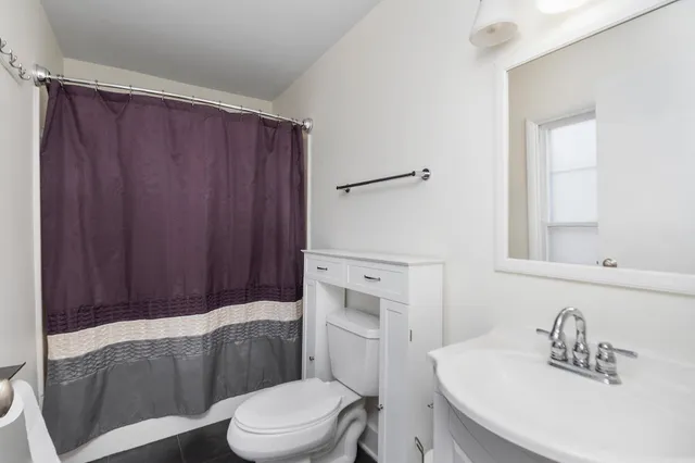 a bathroom with a toilet a sink and bathtub