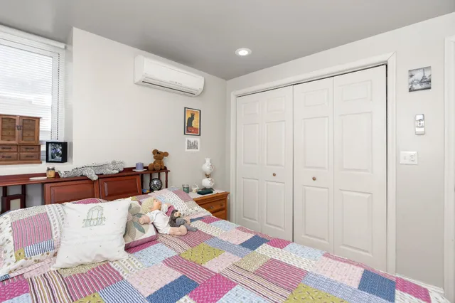 a bedroom with a bed and a couch