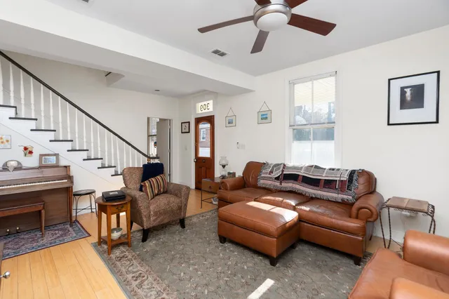 a living room with furniture and a dining table