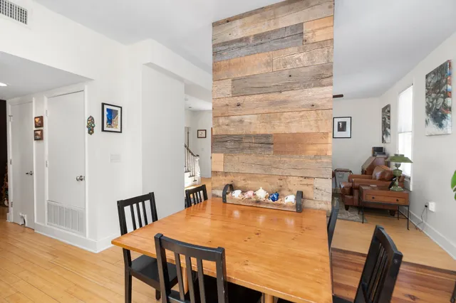 a dining room with furniture and wooden floor