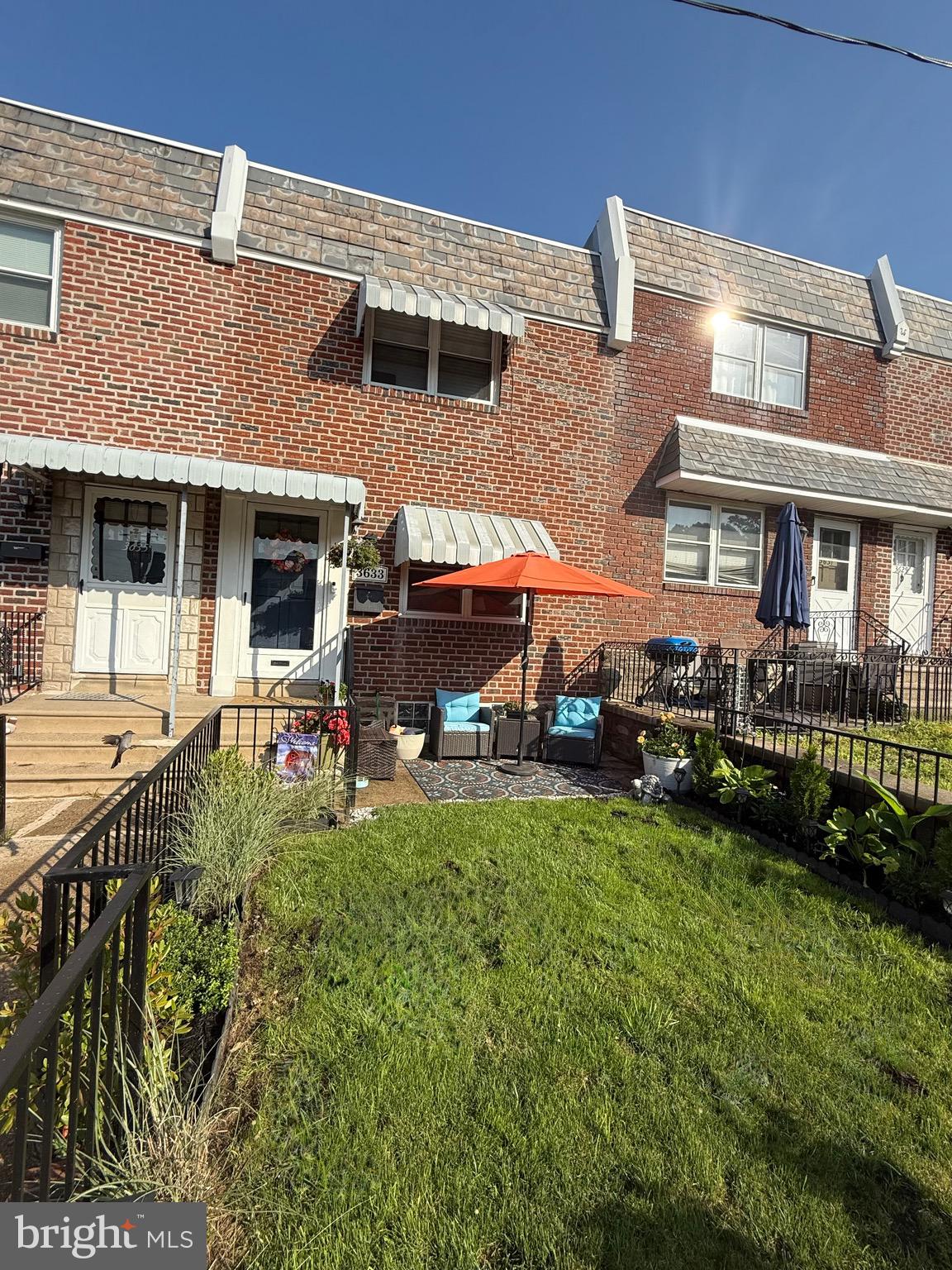 a view of a house with a yard porch and sitting area