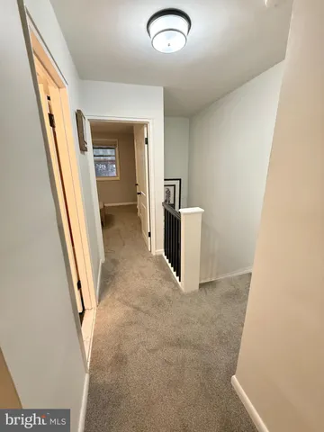 a view of a hallway to rooms