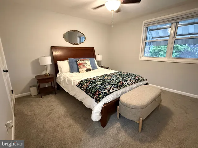 a bedroom with a bed and window