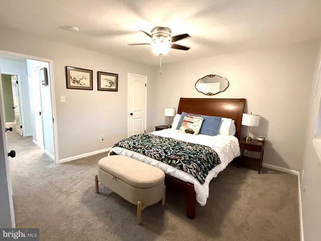 a bedroom with a bed and painting on the wall