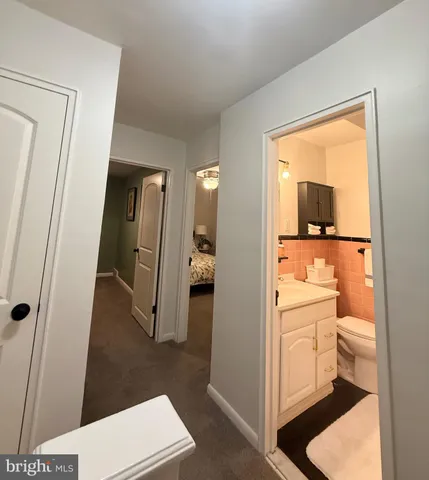a bathroom with a toilet sink and a mirror