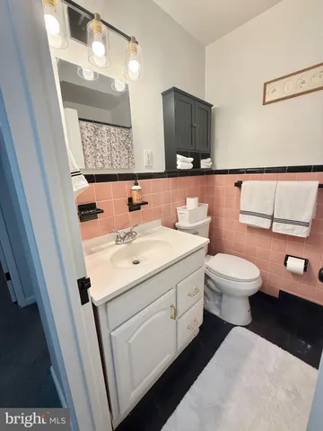 a bathroom with a sink a toilet and a mirror