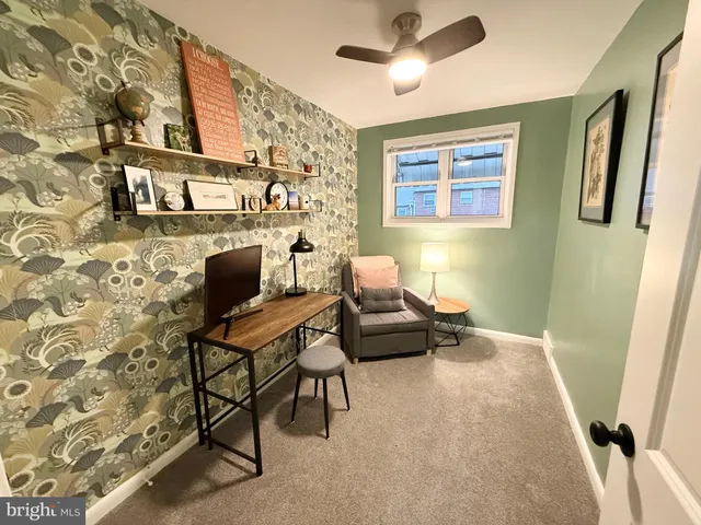 a living room with furniture and a rug