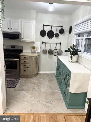 a kitchen with a sink a stove and cabinets