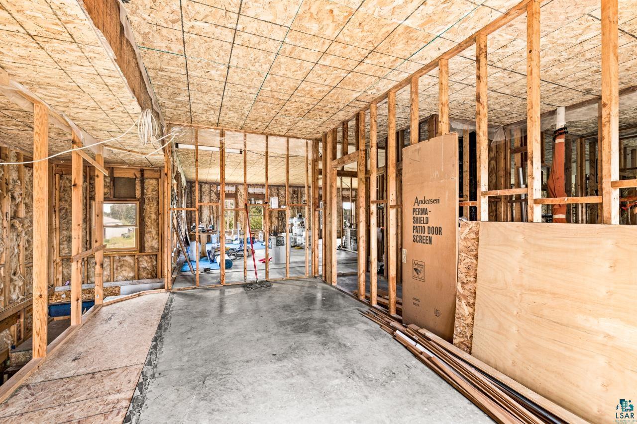 4800 Tower Road Moose Lake, MN 55767 - Photo 73 of 83 Interior framing with exposed wood studs, OSB ceiling, and concrete slab flooring