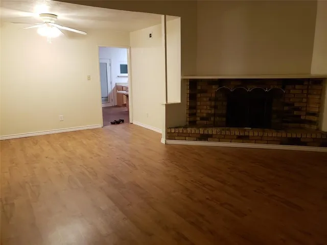 a view of a room with wooden floor