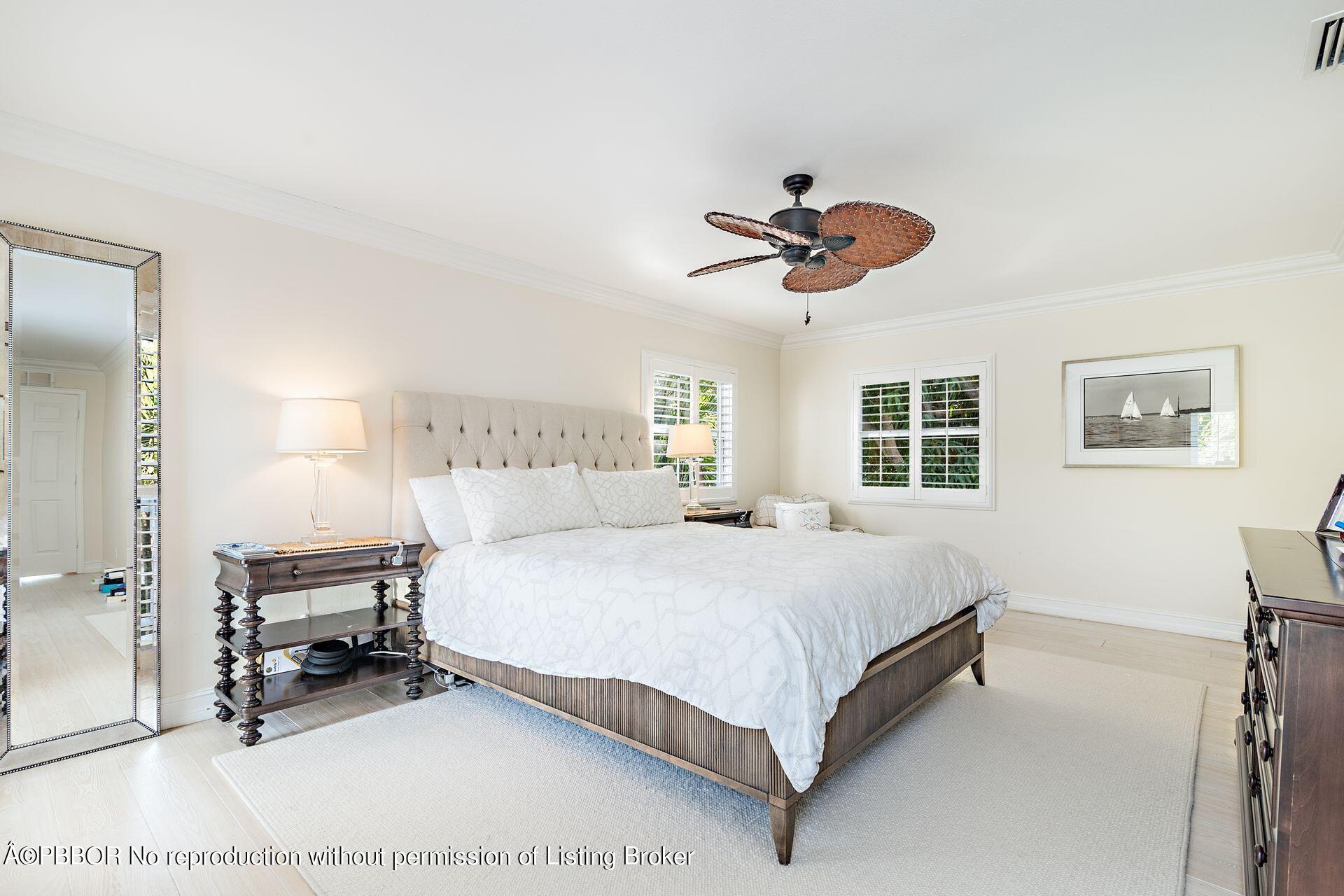 230 Alpine Road West Palm Beach, FL 33405 - Photo 13 of 31 a bedroom with a bed a chandelier and a window