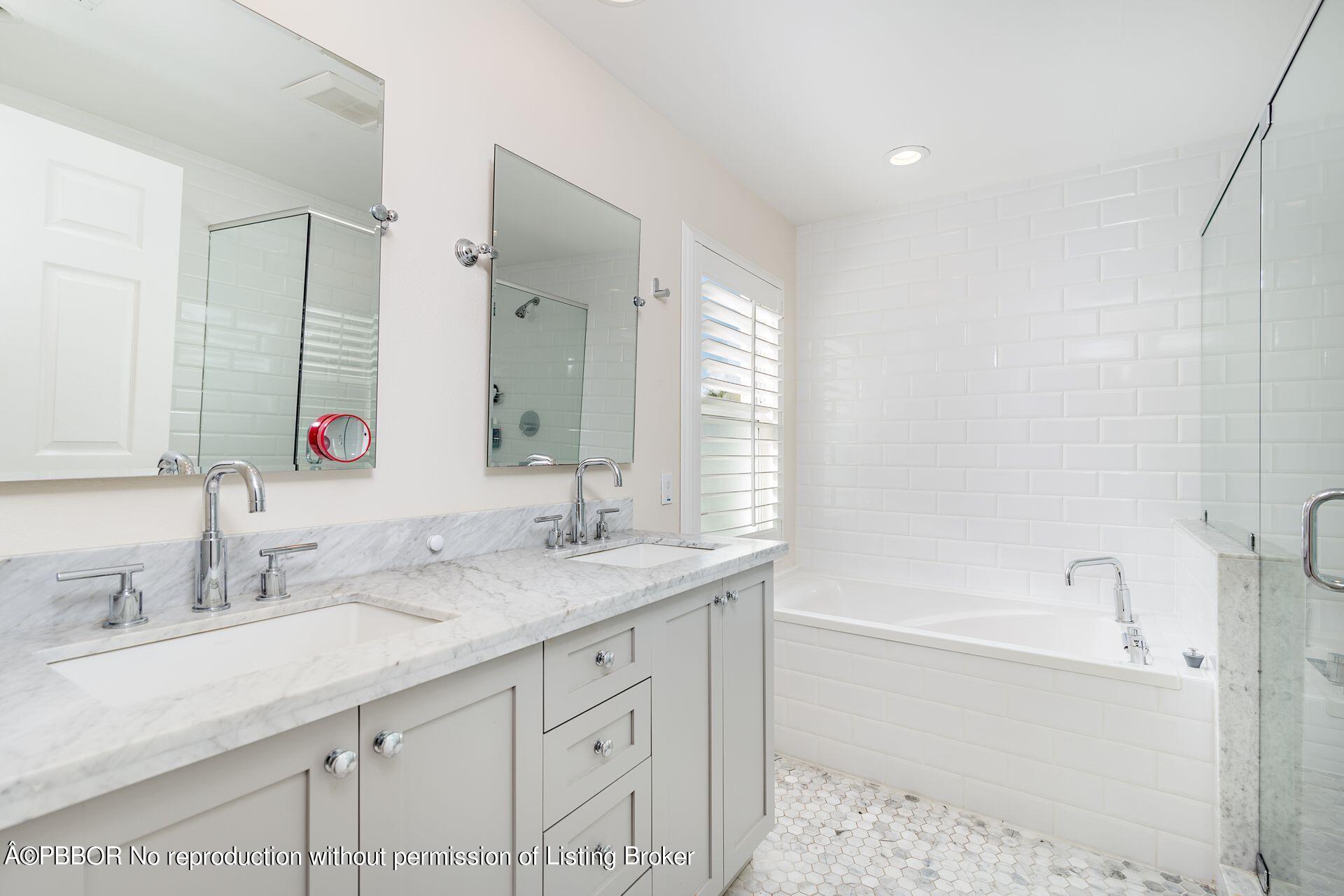 230 Alpine Road West Palm Beach, FL 33405 - Photo 14 of 31 a bathroom with a sink double vanity granite tub shower and a mirror