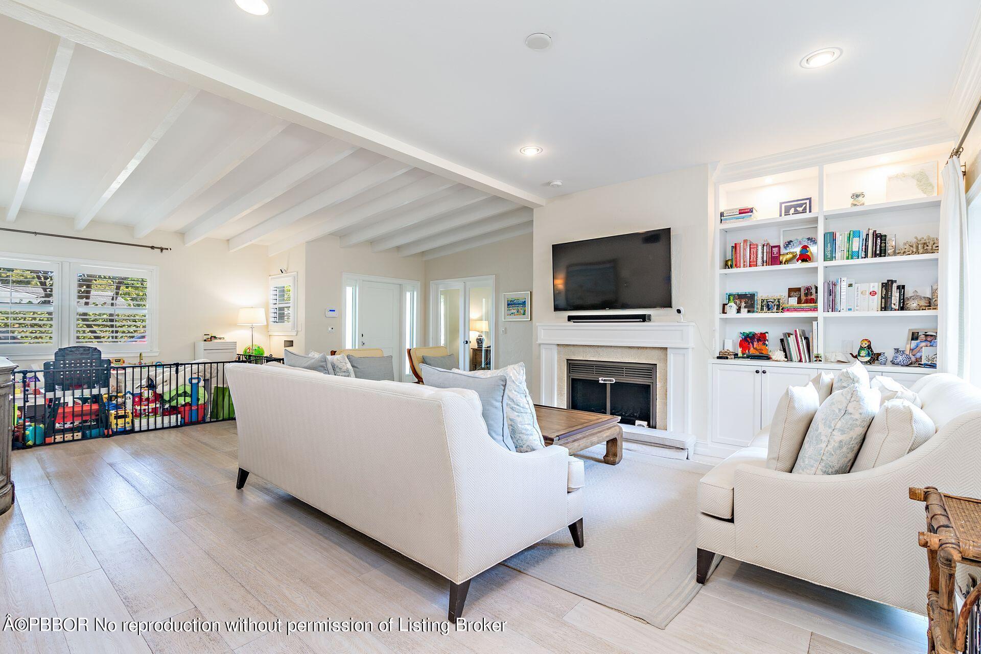 230 Alpine Road West Palm Beach, FL 33405 - Photo 6 of 31 a living room with furniture a fireplace and a flat screen tv