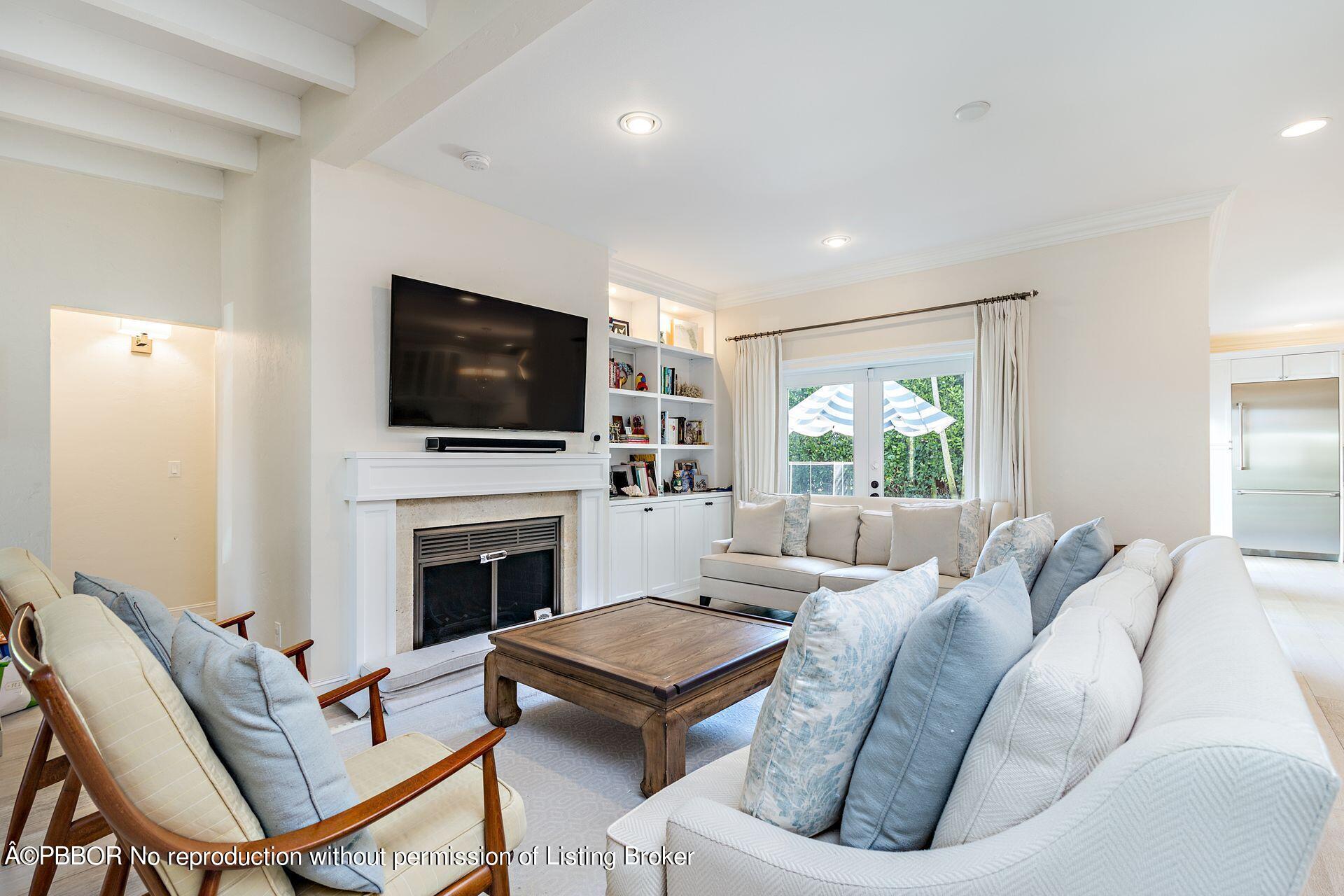 230 Alpine Road West Palm Beach, FL 33405 - Photo 7 of 31 a living room with furniture a fireplace and a flat screen tv