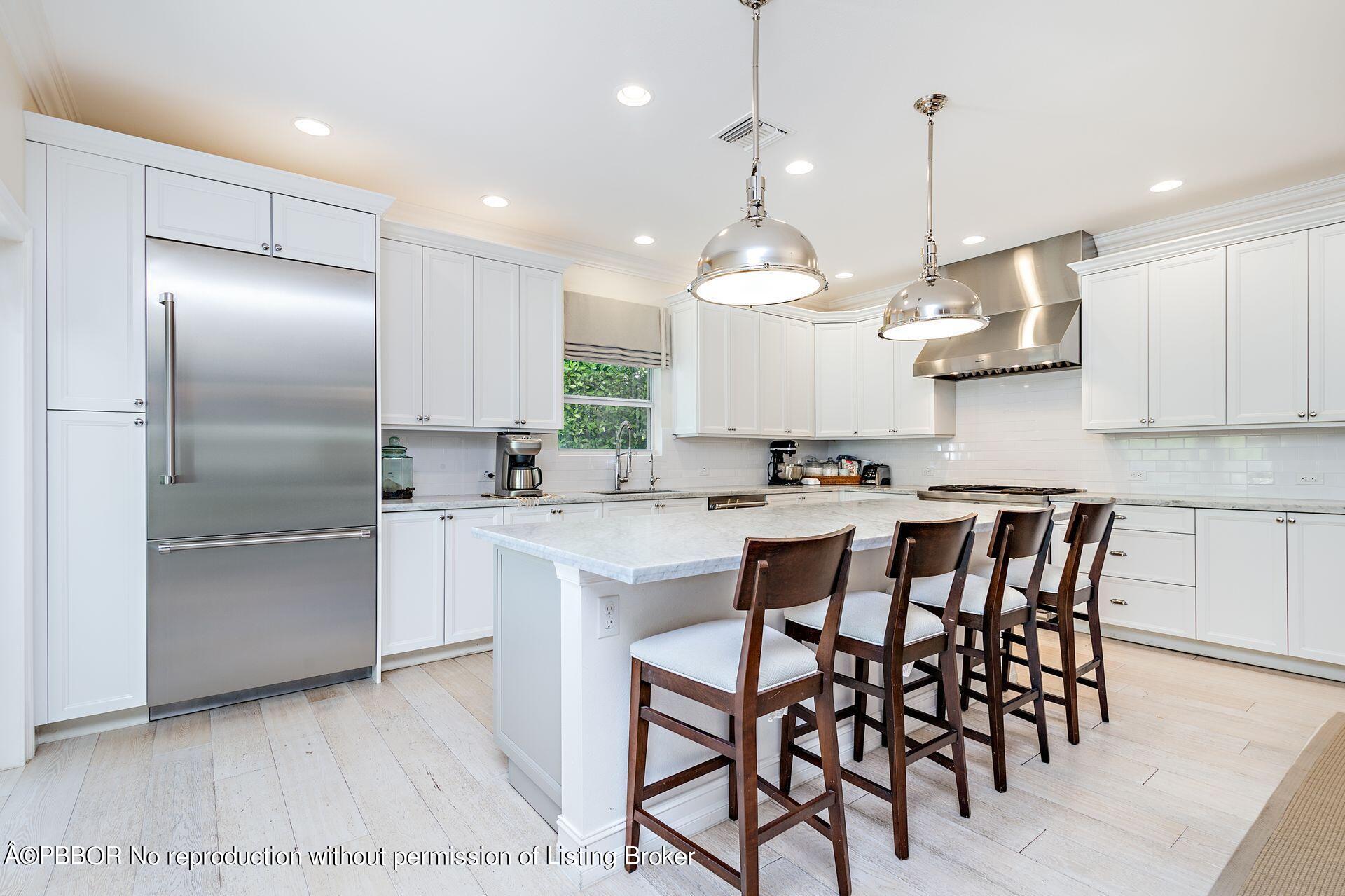 230 Alpine Road West Palm Beach, FL 33405 - Photo 10 of 31 a kitchen with kitchen island granite countertop a sink a center island stainless steel appliances and cabinets