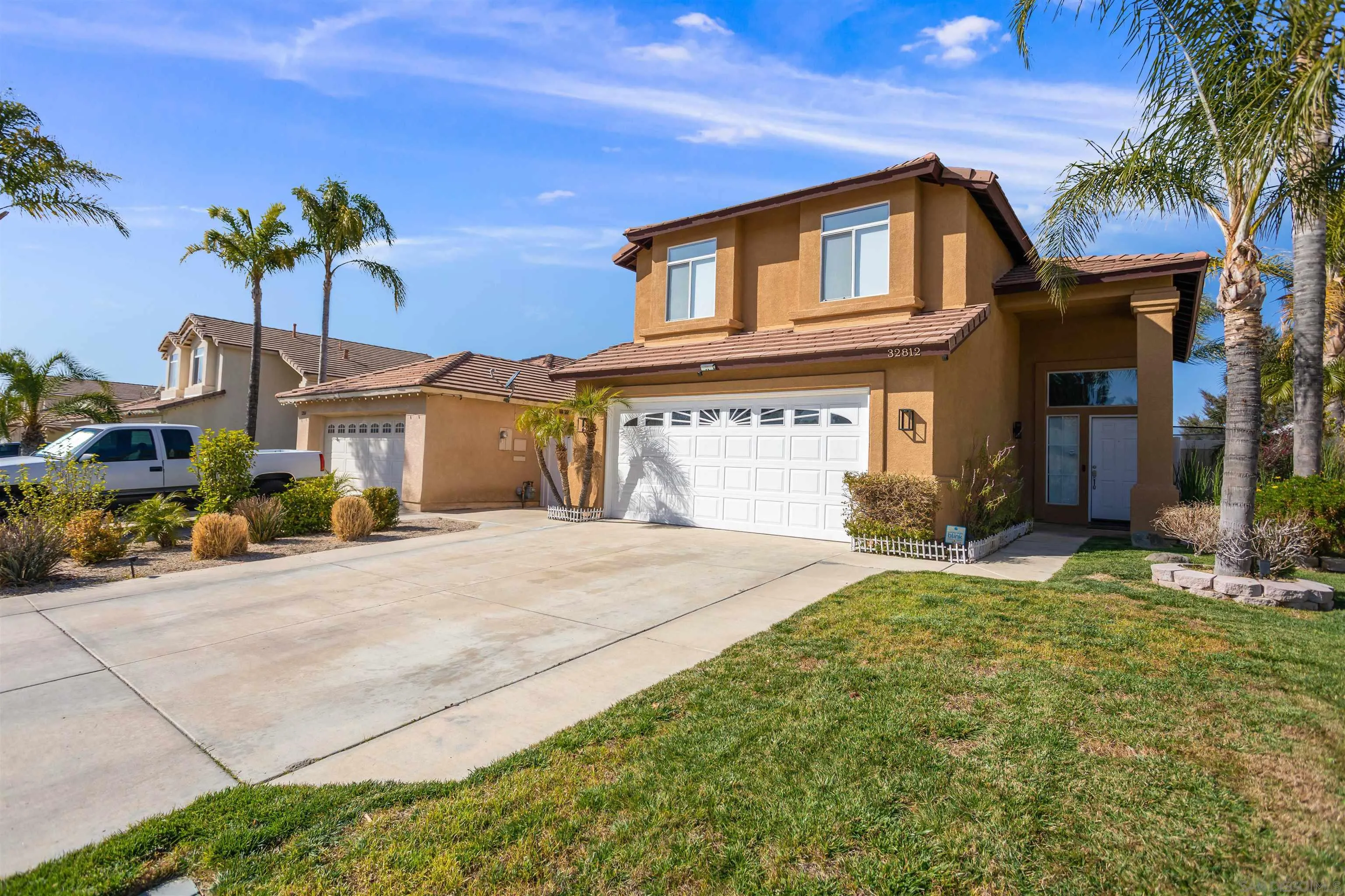 a front view of a house with a yard and a garage