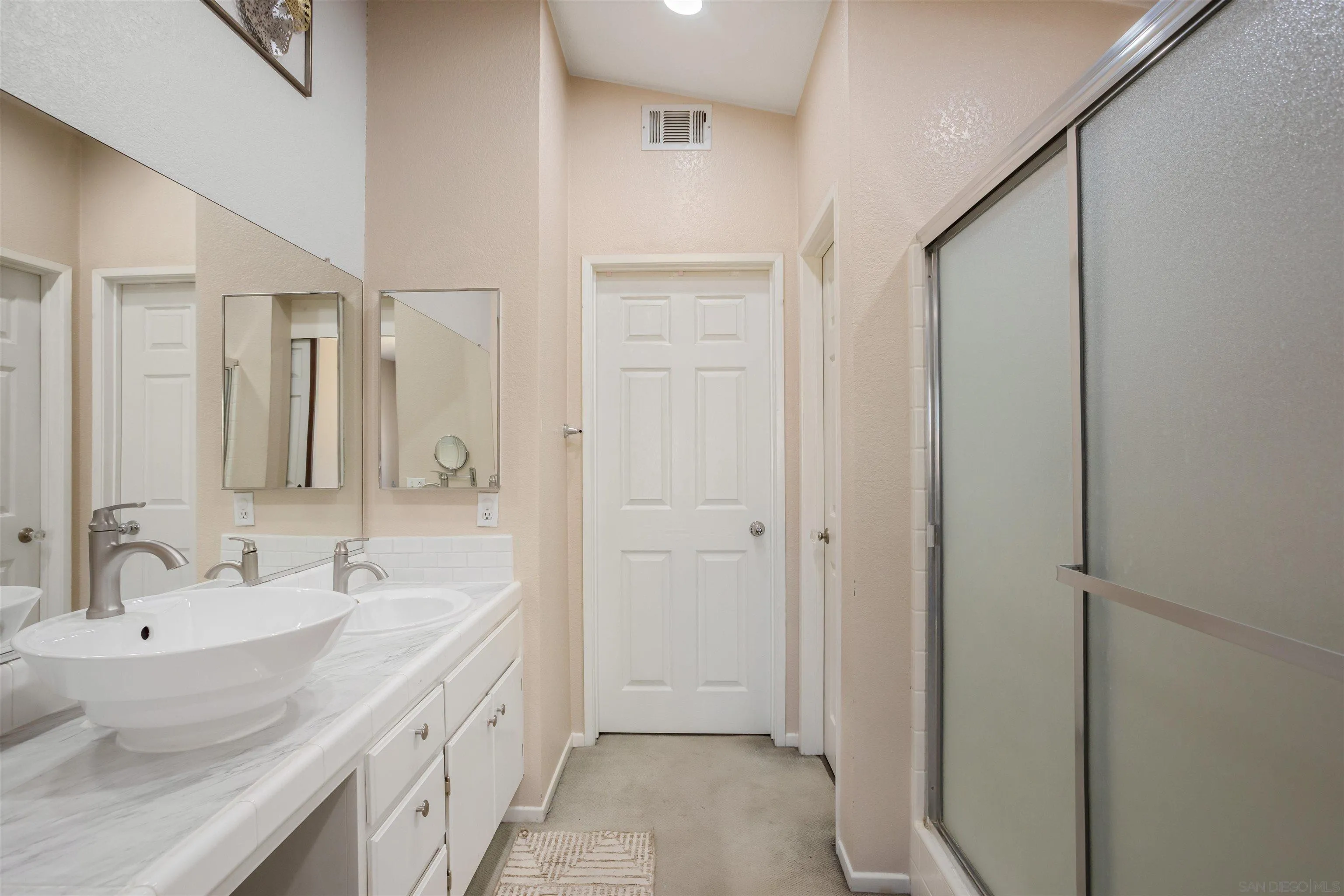 32812 Tulley Ranch Road Temecula, CA 92592 - Photo 17 of 35 a spacious bathroom with a double vanity sink a mirror and a shower