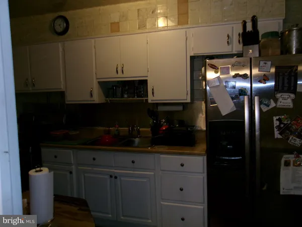 a kitchen with a refrigerator and cabinets