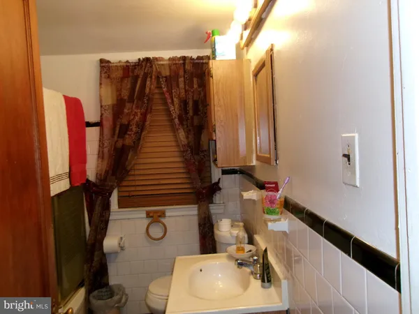 a bathroom with a sink toilet and mirror