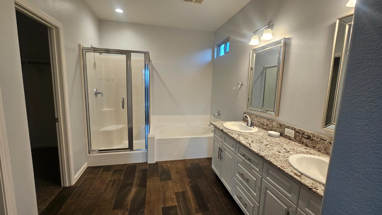 3351 Cordova Avenue Clovis, CA 93619 - Photo 11 of 33 a bathroom with a granite countertop double vanity sink a mirror and a bathtub