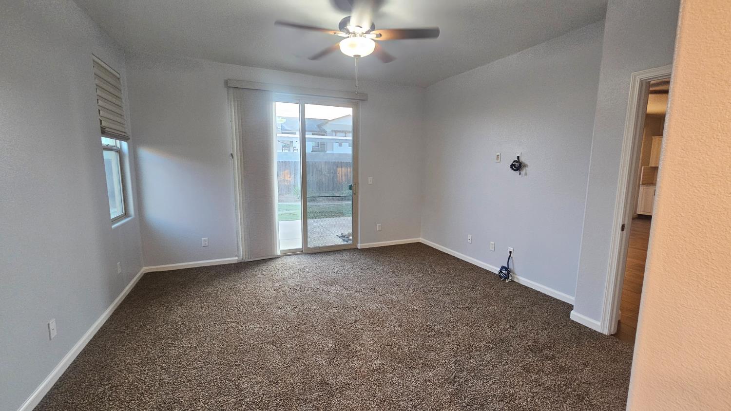 3351 Cordova Avenue Clovis, CA 93619 - Photo 15 of 33 an empty room with chandelier fan and windows