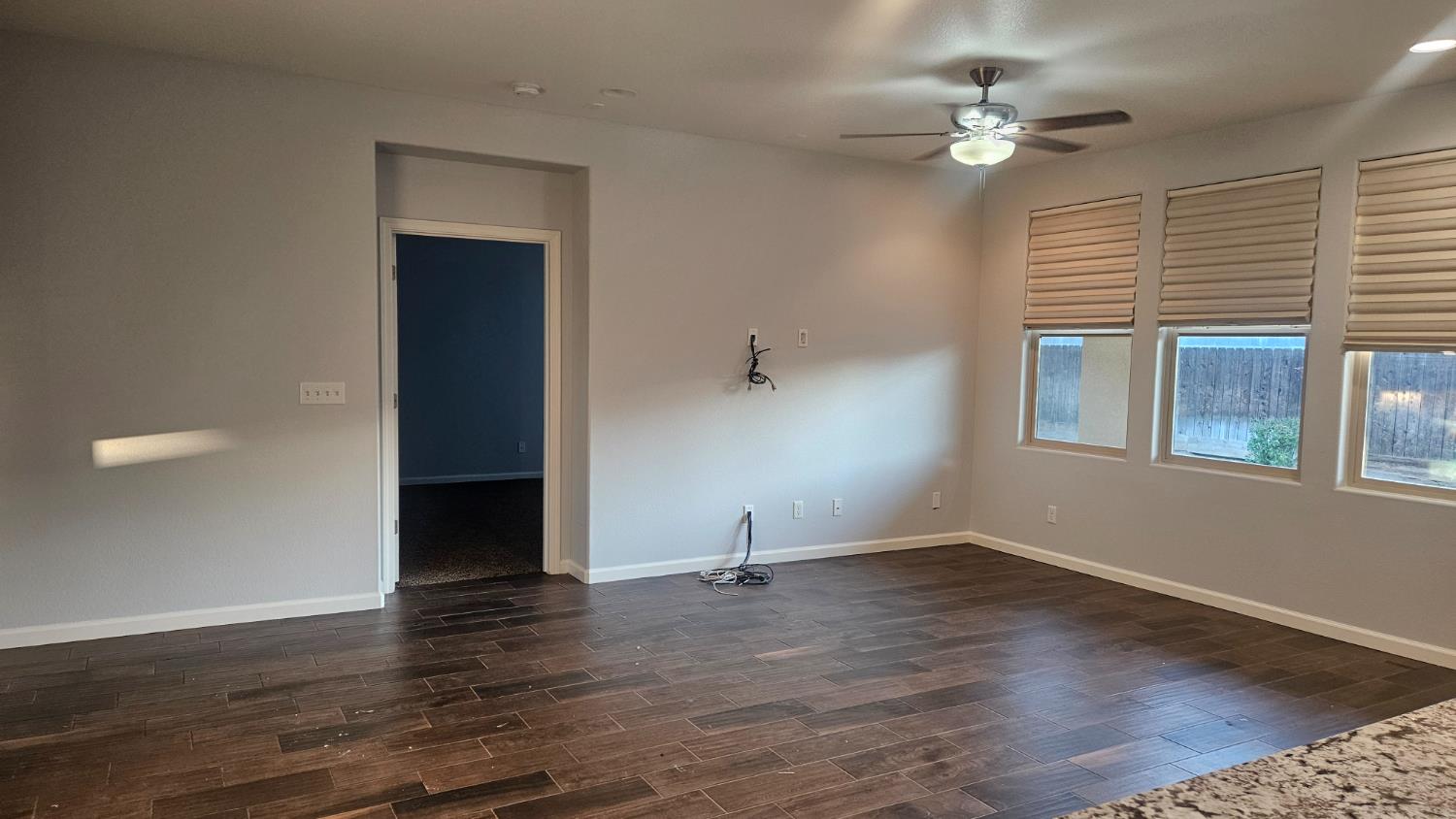 3351 Cordova Avenue Clovis, CA 93619 - Photo 21 of 33 a view of an empty room with wooden floor and a window