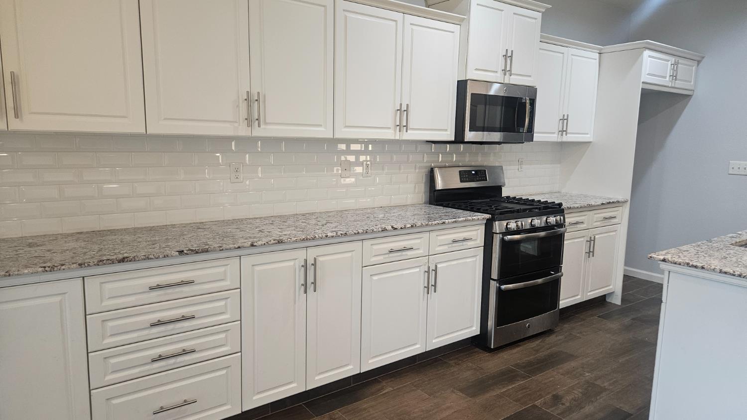 3351 Cordova Avenue Clovis, CA 93619 - Photo 27 of 33 a kitchen with granite countertop white cabinets and stainless steel appliances