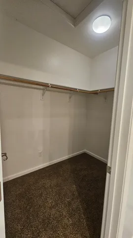 a bathroom with a granite countertop double vanity sink a mirror and a bathtub