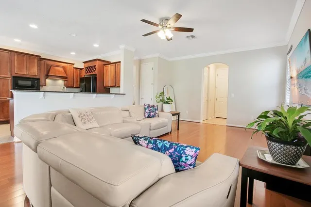 a living room with furniture flowerpot and a chandelier