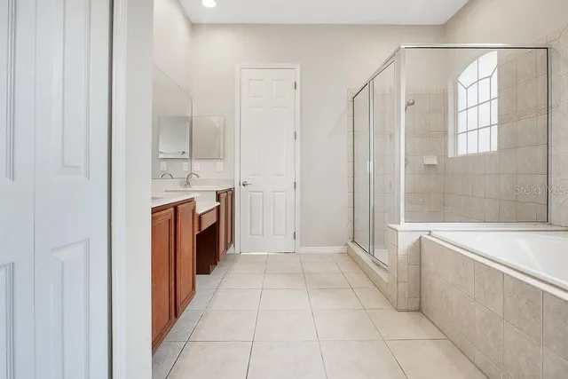 a view of a kitchen with stainless steel appliances granite countertop a sink and a refrigerator