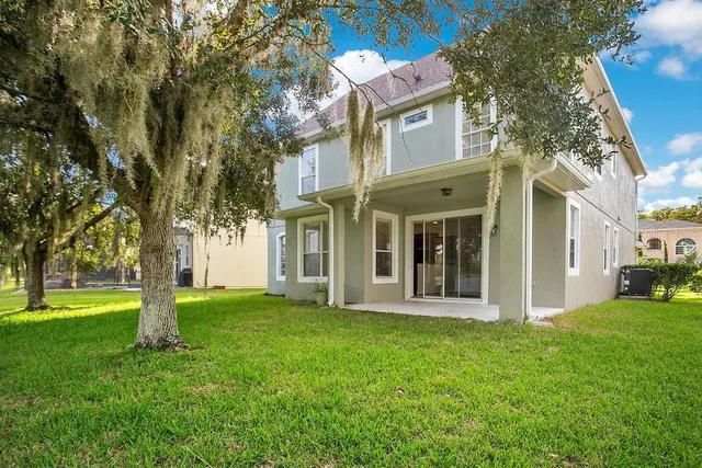a view of a brick house with a yard