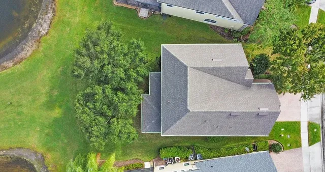 an aerial view of a house with a yard