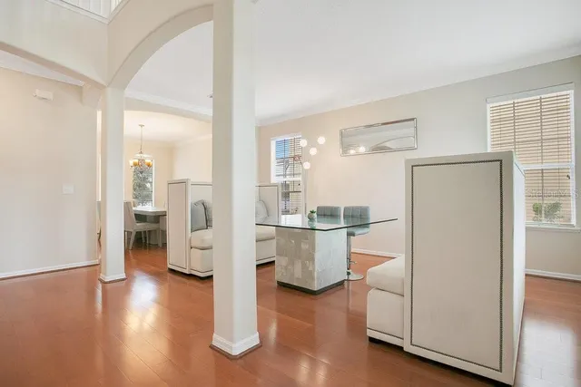 a kitchen with a refrigerator and wooden floor