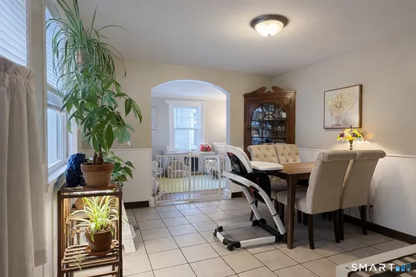 a view of a dining room with furniture and chandelier