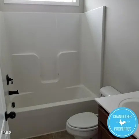 a white toilet sitting next to a bath tub
