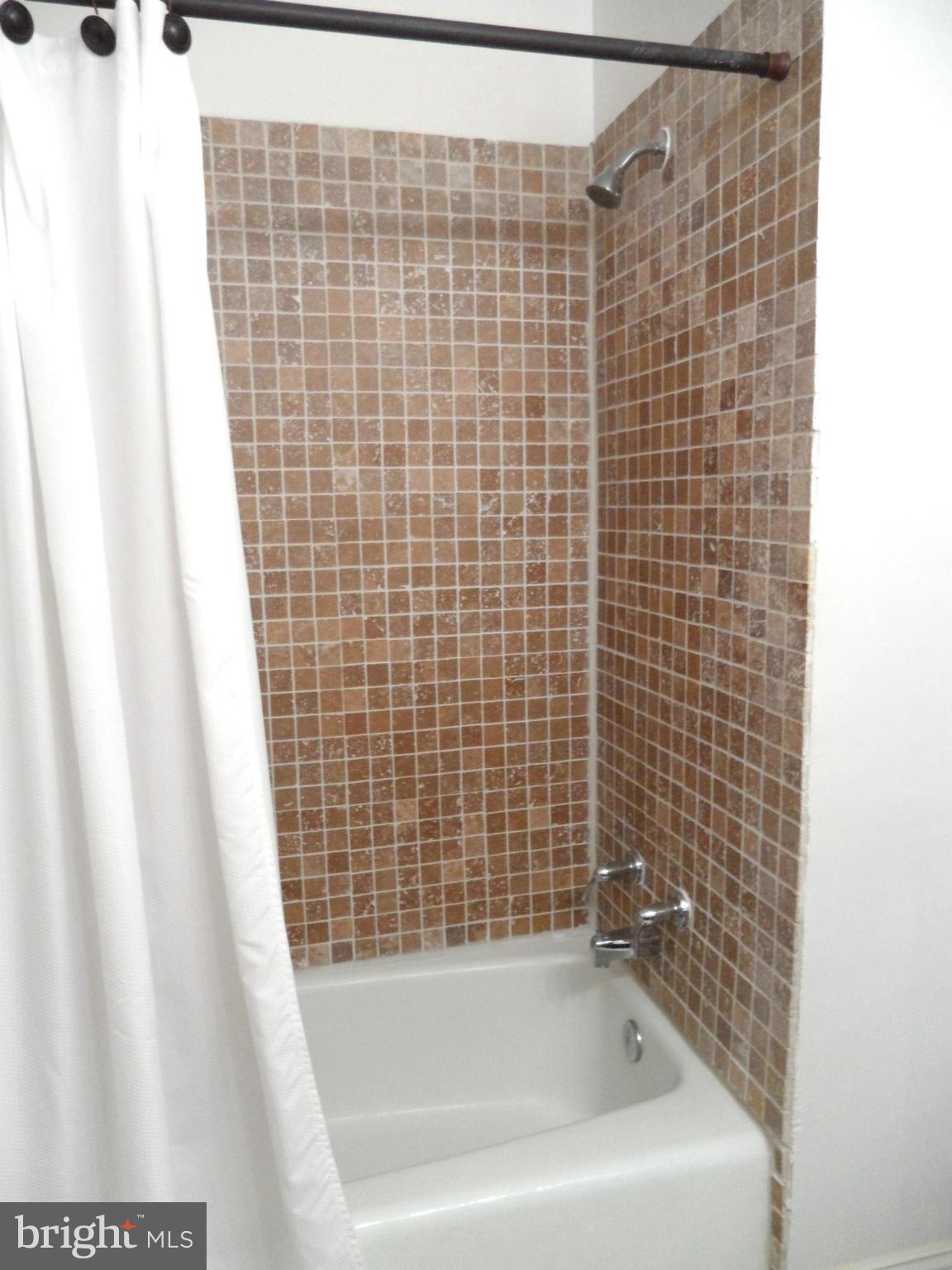 1420 Northgate Square, Unit 21B Reston, VA 20190 - Photo 11 of 30 Hall Bath with Tiled Tub Surround