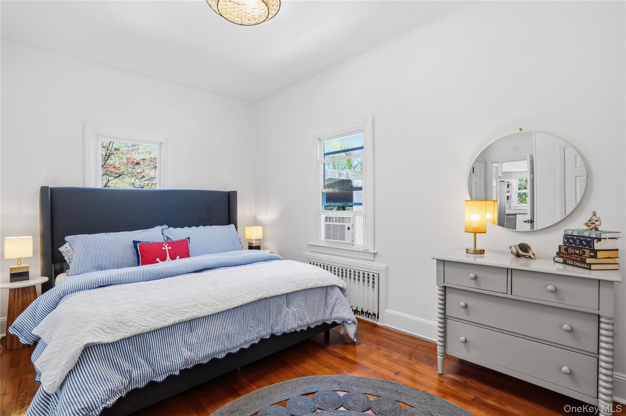 1550 Main Road Riverhead, NY 11901 - Photo 11 of 28 Bright room featuring wood-finish flooring, white walls, and a decorative ceiling fixture